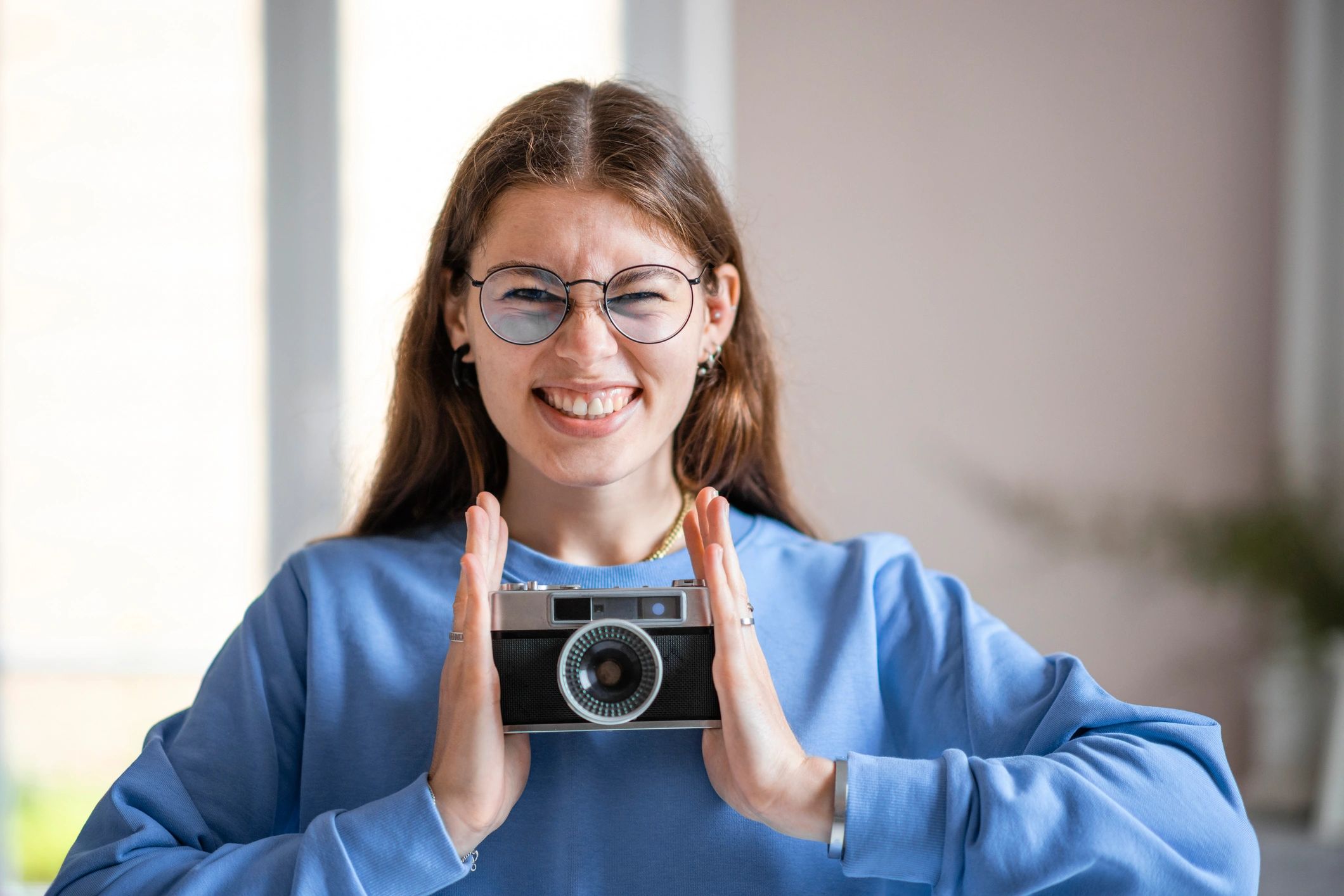 Smiling photographer with camera ready to shoot